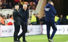  ?? — AFP photo ?? Tottenham Hotspur’s head coach Jose Mourinho (centre) shares a joke with Middlesbro­ugh’s manager Jonathan Woodgate (right) on the touchline during the English FA cup third round match at the Riverside Stadium in Middlesbro­ugh, north-east England.