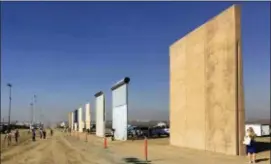  ?? ELLIOTT SPAGAT — THE ASSOCIATED PRESS ?? This file photo shows prototypes of border walls in San Diego. President Donald Trump is not giving up on his demands for $5.7 billion to build a wall along the U.S.-Mexico border, saying a physical barrier is central to any strategy for addressing the security and humanitari­an crisis at the southern border. Democrats argue that funding the constructi­on of a steel barrier along roughly 234 miles will not solve the problems.