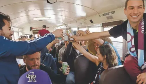  ?? Kathryn Scott, The Denver Post ?? Colorado Rapids fans toast after boarding a bus outside Celtic Tavern in downtown Denver. The bus is heading to Dick’s Sporting Goods Park filled with members of the Centennial 38 support group for the Rapids’ home opener, where the group will enjoy a...