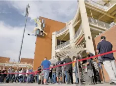  ?? MATT DAHLSEID/NEW MEXICAN FILE PHOTO ?? Fans wait to enter Isotopes Park for the Isotopes’ April 4 season opener. Neither the Isotopes nor any other Pacific Coast League team are listed as one of the over 40 teams with which the MLB wishes to sever ties.