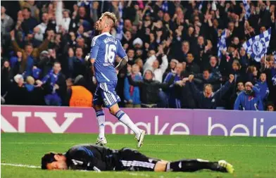  ??  ?? Down and out: Chelsea’s Raul Meireles celebrates after beating Benfica goalkeeper Artur on Wednesday. — EPA