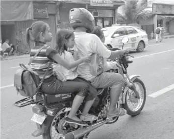  ??  ?? Without wearing the prescribed safety gears, these children rode a motorcycle on their way to school, unmindful of the risks that this mode of transporta­tion poses. In Cebu City, a legislativ­e committee has junked a resolution seeking to practicall­y...