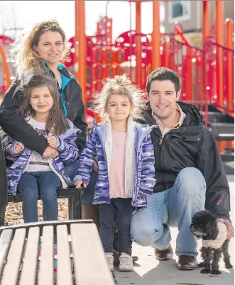  ?? DON MOLYNEAUX ?? Jonas and Erin Lirantzis with their daughters Isabella and Madelyn and their dog Marlee at a playground in the community of Fireside in Cochrane, where a nearby school is an important feature for them.