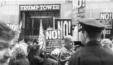  ??  ?? Protesters gather outside of Trump Tower a day after Comey was fired by Trump. — AFP photo