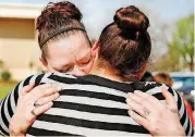  ?? [PHOTO BY JIM BECKEL, THE OKLAHOMAN] ?? Elizabeth Conaway, left, mother of Austin Almanza, 10, cries while hugging her daughter, Alisa, 13, outside the Lincoln County Courthouse.