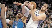  ?? [AP PHOTO] ?? Oklahoma City Thunder guard Russell Westbrook, left, and Sacramento Kings center Kosta Koufos battle for the ball during Tuesday night’s game in Sacramento, Calif.