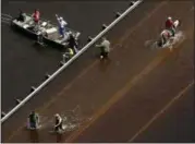  ?? CHARLIE RIEDEL — THE ASSOCIATED PRESS ?? People are surrounded by water from the flooded Brazos River in the aftermath of Hurricane Harvey Sept. 1, in Freeport, Texas.