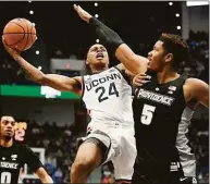  ?? Jessica Hill / Associated Press ?? UConn’s Jordan Hawkins (24) shoots while defended by Providence’s Ed Croswell (5) on Dec. 18 at the XL Center in Hartford.