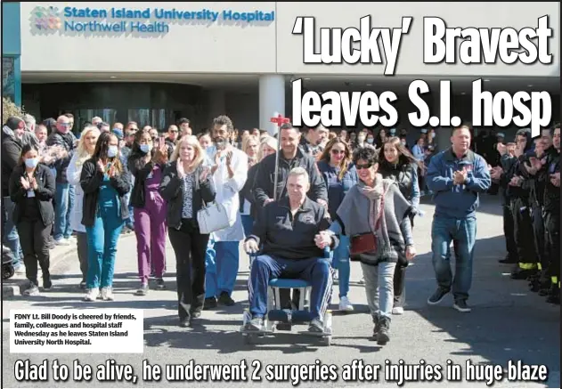  ?? ?? FDNY Lt. Bill Doody is cheered by friends, family, colleagues and hospital staff Wednesday as he leaves Staten Island University North Hospital.