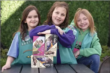  ?? JOEL ROSENBAUM / THE REPORTER ?? Alexandria Keane, 9(left), Kenslie Reding, 9(middle), and Rylie Reding, 9, members of Vacaville Girl Scout Troop 30175, want cookie lovers to know that the pre-sale of Girl Scout cookies began Wednesday and cookies will go on sale in public locations March 20.