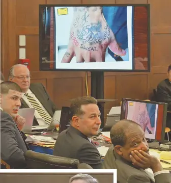  ?? STAFF PHOTOS BY CHRIS CHRISTO ?? DETAILS: California tattoo artist David Nelson, left, describes the designs he did for Aaron Hernandez, far left, in 2013 during Hernandez’s trial yesterday. Attorneys for the former Patriot star, above, argued tattoos of guns and bullets are not proof that their client killed two men in June 2012.