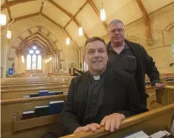  ?? BERNARD WEIL/TORONTO STAR ?? All Saints’ Anglican Church Archdeacon Stephen Vail and parishione­r Roy Allam inside the rebuilt church. The 2009 fire caused about $5 million in damage.