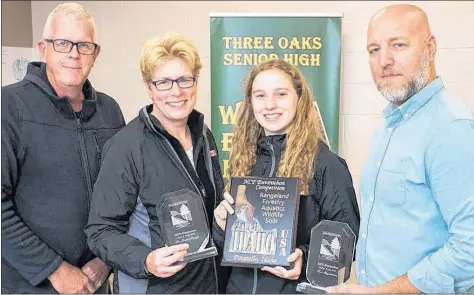  ?? SUBMITTED PHOTO ?? Ken Mayhew, left, Provincial Forest Envirothon co-ordinator congratula­tes Three Oaks Senior High teachers Heather Pringle and Chris Higgenboth­am for being inducted into the NCF Envirothon Hall of Fame in Idaho over the summer. Looking on is Sarah Hall, a student from the 2018 Three Oaks Envirothon team.