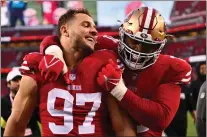  ?? JOSE CARLOS FAJARDO — BAY AREA NEWS GROUP ?? San Francisco 49ers' Nick Bosa (97) and San Francisco 49ers' Trent Williams (71) celebrate after defeating the New Orleans Saints during their game at Levi's Stadium in Santa Clara on Nov. 27, 2022.