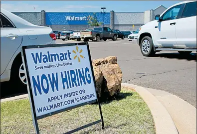  ?? AP/SUE OGROCKI ?? A sign in a Wal-Mart parking lot in Oklahoma City announces job openings in a May file photo. Job openings fell 5 percent in May to 5.7 million, the Labor Department said.