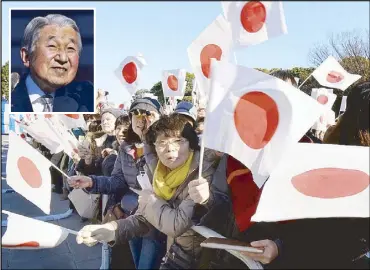  ??  ?? Citizens wave flags to celebrate the 84th birthday of Japanese Emperor Akihito at the Imperial Palace in Tokyo yesterday.