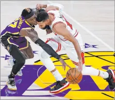  ?? Ashley Landis The Associated Press ?? Lakers guard Dennis Schroder pressures Bulls guard Garrett Temple in the first quarter of Los Angeles’ 117-115 win Friday at Staples Center.