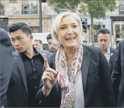  ??  ?? Far right candidate Marine Le Pen gestures to the media and onlookers after getting a haircut in Paris,.