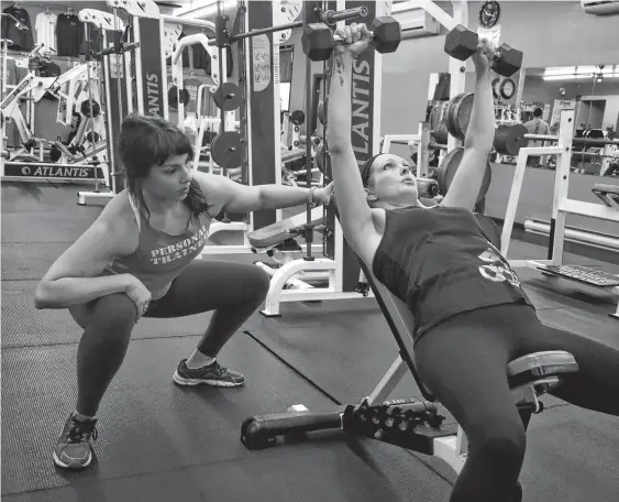  ?? NICOLE SULLIVAN • CAPE BRETON POST ?? Vicky McNeil of New Waterford, left, watches client Jennifer Budden-White’s form during a set of inclined chest press exercises in January of 2019.