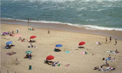  ?? Photograph: Kevin Lamarque/Reuters ?? A beach in Ocean City, Maryland, where topless sunbathing is banned.