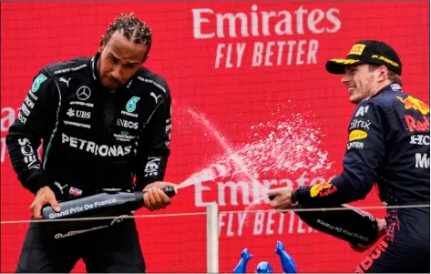  ?? AP Photo/Francois Mori ?? Red Bull driver Max Verstappen of the Netherland­s (right) celebrates from the podium after winning with second place Mercedes driver Lewis Hamilton of Britain from the podium during the French Formula One Grand Prix at the Paul Ricard racetrack in Le Castellet, southern France, on Sunday.