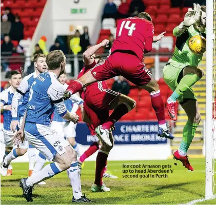  ??  ?? Ice cool: Arnason gets up to head Aberdeen’s second goal in Perth