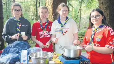  ?? (Pic: John Ahern) ?? L-r: sisters, Lucy and Katie O’Connell with Joanne Cogan and Anita Castro, preparing food at last Saturday’s Ballyhooly scouts Informatio­n Day in Castlebla Forest.