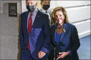  ?? J. SCOTT APPLEWHITE/AP ?? President Joe Biden and Speaker of the House Nancy Pelosi walk in a basement hallway of the Capitol after meeting with House Democrats.