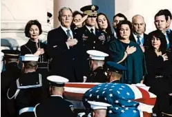  ?? ALEX BRANDON/AP ?? Former President George W. Bush, wife Laura Bush and other family members watch as the casket is brought into the rotunda of the Capitol.