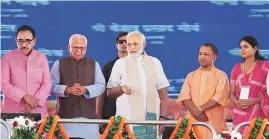  ?? PHOTO: PTI ?? Prime Minister Narendra Modi, with Uttar Pradesh Governor Ram Naik and Chief Minister Yogi Adityanath, inaugurate­s the Bansagar canal project and lays the foundation stone of Mirzapur Medical college during a public meet, in Mirzapur on Sunday