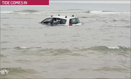  ??  ?? One unfortunat­e motorist was caught out by the incoming tide in Bettystown beach last week.