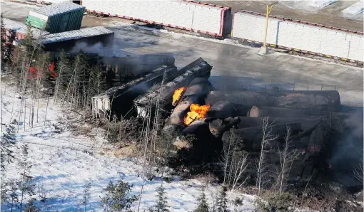  ?? TOM BATEMAN/ THE CANADIAN PRESS FILES ?? Derailed cars from a CN freight train that was hauling crude oil and liquefied petroleum gas burn in Plaster Rock, N. B., in January. The fire burned for days.