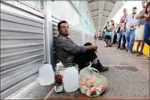  ?? AP/DAVID J. PHILLIP ?? Ruben Prado, an immigrant from Guatemala seeking asylum in the United States, waits on the Gateway Internatio­nal Bridge on Sunday in Matamoros, Mexico. Prado arrived at the bridge after traveling for 20 days.