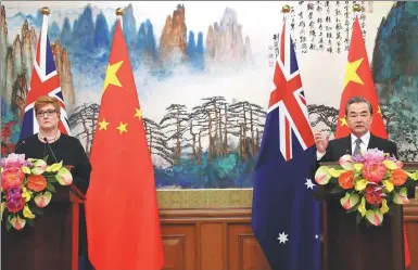  ?? WANG JING / CHINA DAILY ?? State Councilor and Foreign Minister Wang Yi meets the press with visiting Australian Foreign Minister Marise Payne in Beijing on Thursday.