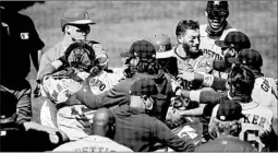  ?? BEN MARGOT/AP ?? The Astros and Athletics benches clear during a brawl Sunday in Oakland.