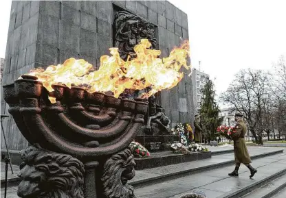  ?? Czarek Sokolowski / Associated Press ?? Wreaths are laid at the monument to the Heroes of the Warsaw Ghetto on Wednesday in Poland, part of global events.