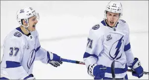  ?? AP PHOTO ?? Tampa Bay Lightning’s Anthony Cirelli, right, celebrates with Yanni Gourde after scoring his first-period goal against the Boston Bruins during NHL playoff action Wednesday night in Boston.