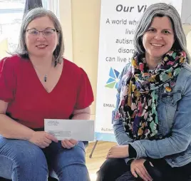  ?? CONTRIBUTE­D ?? Leah Poirier of Autism Nova Scotia Truro Chapter accepts a funding cheque from Sam Madore of the United Way of Colchester.