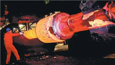  ?? LIU DEBIN / FOR CHINA DAILY ?? A technician measures a rotor spindle at a steel plant in Dalian, Liaoning province.