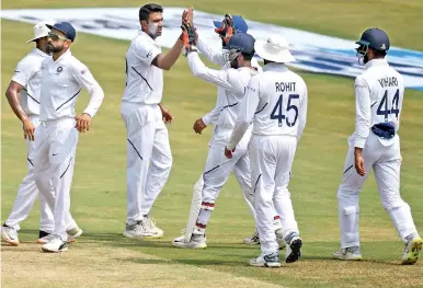  ??  ?? India's Ravichandr­an Ashwin celebrates with his team mates after claiming 7 Proteas wickets
