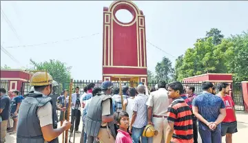  ??  ?? Parents gather outside Ryan Internatio­nal School, Bhondsi. An 8yearold was found dead with his throat slit inside the school on Friday morning. SANJEEV VERMA/HT PHOTO