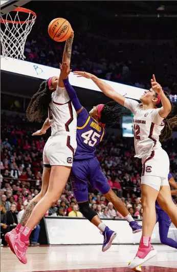  ?? Lance King / Getty Images ?? South Carolina’s Kamilla Cardoso blocks a shot by LSU’S Alexis Morris during the third quarter of their Southeaste­rn Conference matchup on Sunday in Columbia, South Carolina. South Carolina won 88-64 behind Cardoso’s 18 points and 13 rebounds.