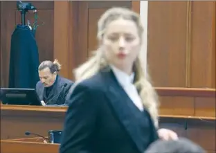  ?? Jim Lo Scalzo Pool Photo ?? AMBER HEARD faces her legal team in court last month as Johnny Depp is on the witness stand. Defamation lawsuits can take a financial and psychologi­cal toll on accusers.