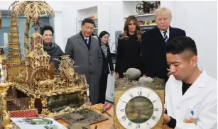  ?? (Liu Weibing/Xinhua/Sipa USA/TNS) ?? CHINESE PRESIDENT Xi Jinping and his wife Peng Liyuan, along with US President Donald Trump and first lady Melania Trump, watch the repair of relics at the conservati­on workshop of the Palace Museum in Beijing on Wednesday.