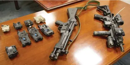  ?? SUN-TIMES FILE ?? Laser gun sights (left) that were seized in an investigat­ion leading to federal gun traffickin­g conviction­s against three Lake County, Indiana, sheriff’s officers in 2011.