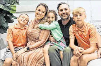  ?? ALEXIA FODERE for The Miami Herald ?? Logan Jenner, 8, left, a former cancer patient at Nicklaus Children’s Hospital, next to his family, mother Diana Jenner, 35; sister Mary, 4; father Michael Jenner, 38; and brother Ashton, 10, at their home in Miami-Dade on March 4. Logan has been cancer-free for more than two years.