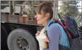  ?? (TNS/Direct Action Everywhere) ?? Alexandra Paul carries a chicken away from a Foster Farms truck in Livingston, Calif., in 2021.