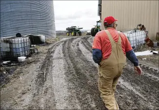  ?? PHOTOS BY NATI HARNIK / ASSOCIATED PRESS ?? Blake Hurst, a corn and soybean farmer in Westboro, Mo., walks to the tractor shed on his farm last month. Many farmers worry that President Donald Trump’s desire to renegotiat­e the North American Free Trade Agreement will jeopardize their exports just...