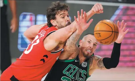  ?? AP ?? Boston Celtics’ Daniel Theis and Toronto Raptors’ Marc Gasol battle for a rebound during Monday’s NBA Eastern Conference semifinal game in Lake Buena Vista, Florida. The Celtics won 111-89 to take a 3-2 lead in the best-of-seven series.