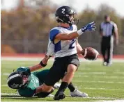  ?? Houston Chronicle ?? Legacy Prep defensive back Jared May (9) drags down Brazos Christian wide receiver Blake Smith (2) during the fourth quarter of a TAPPS Division IV state semifinal game at Cub Stadium, Saturday, Dec. 2, 2017, in Brenham.